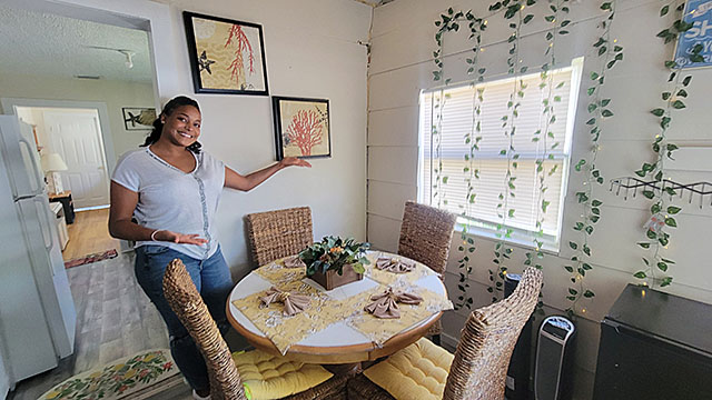 Safae shows off the decorating she's done in her dining room.