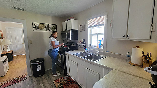 Safae enjoys cooking meals in her kitchen.